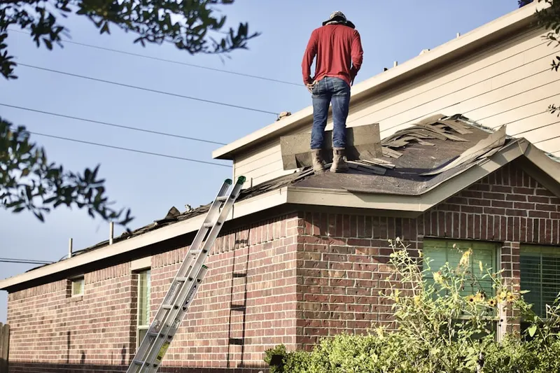 Professional roofer working on a residential roof in Churchill Crossing